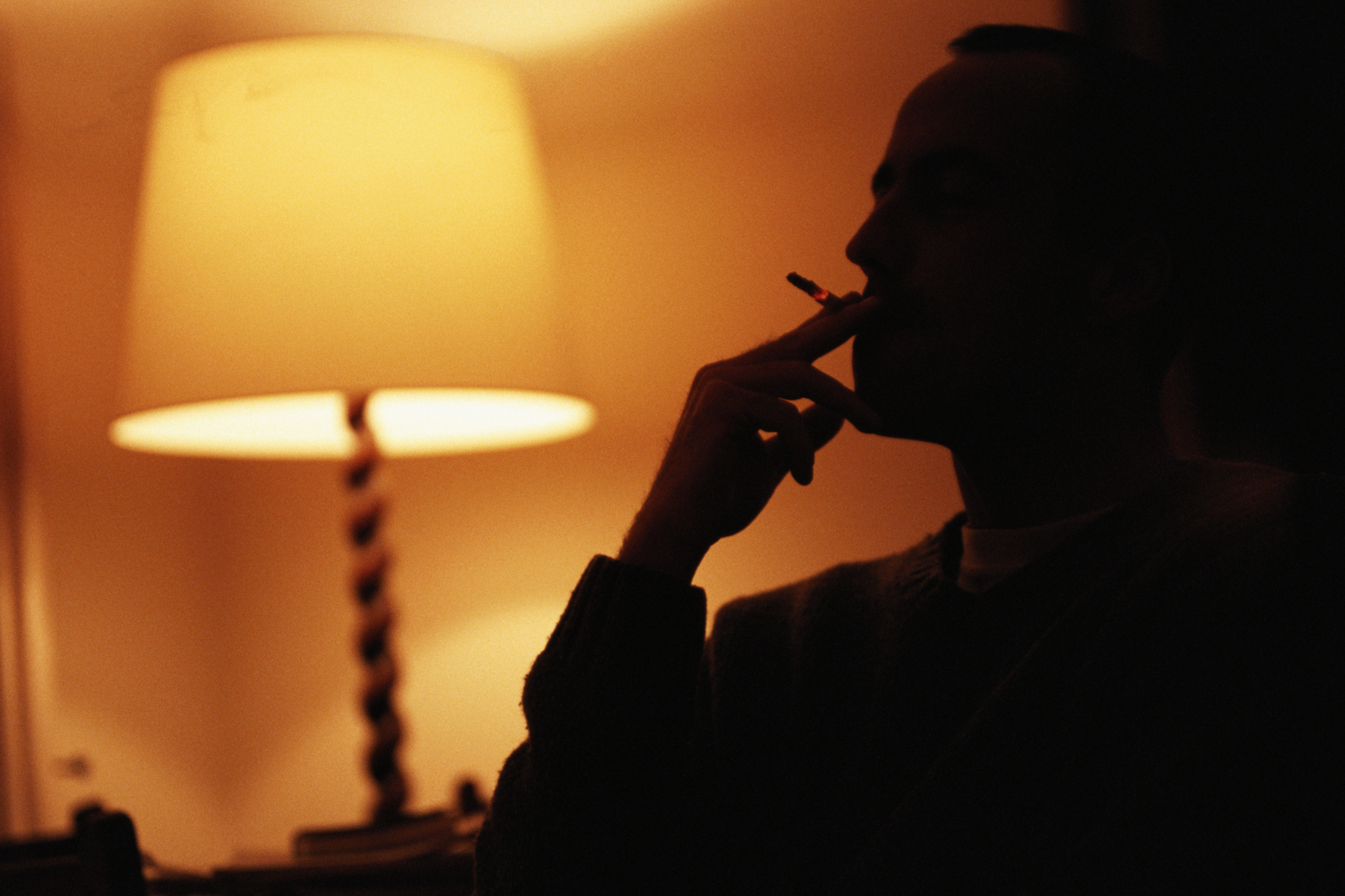 Муж курит в квартире. Парень курит в темноте. Мужчина с сигаретой. Парень с сигаретой в темноте. Человек с сигаретой ночью.